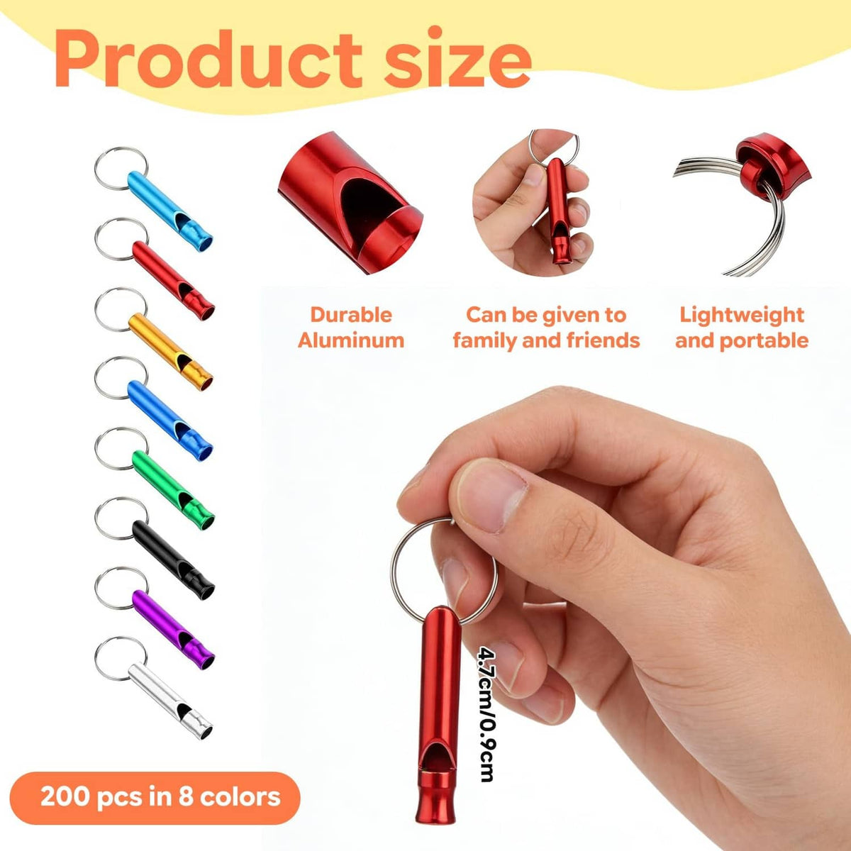Red aluminum signal whistle keychain held in hand with metal loop ring