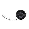 Black fuel tank filler cap with attached vent hose and caution label