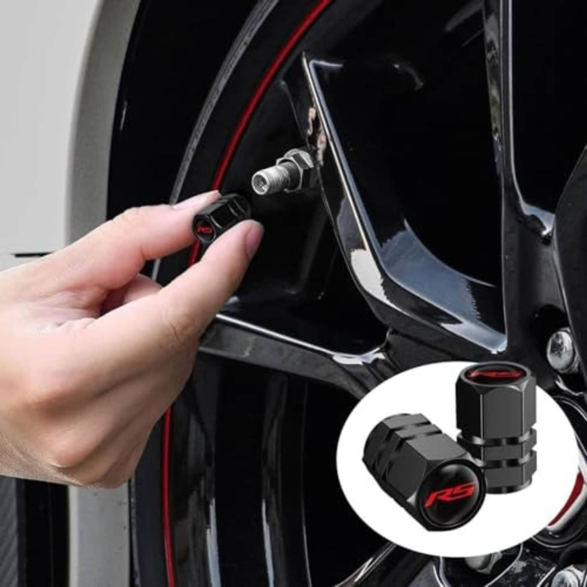 Hand installing a black valve stem cap with red ring and RS logo