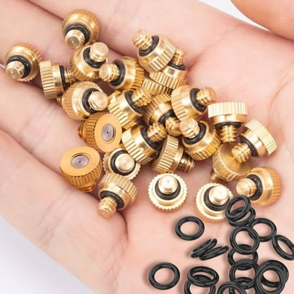 Set of brass misting nozzles with black O-rings, shown in a hand