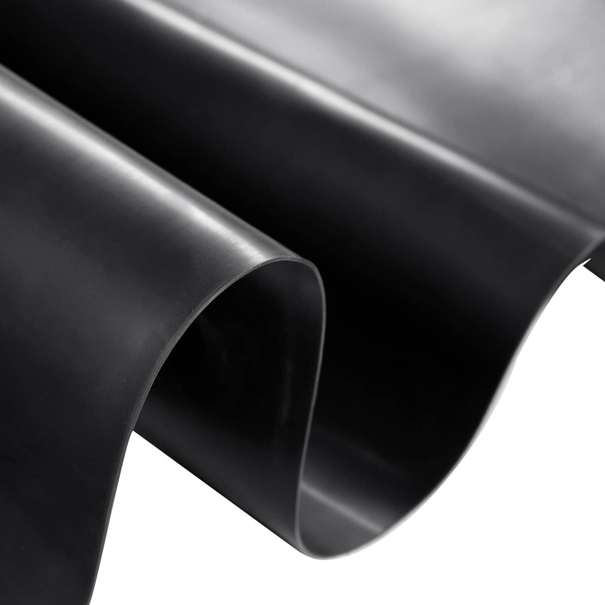 Rolled black pond liner edge view with smooth sheet texture and curved fold