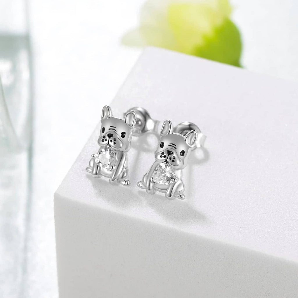 Silver French bulldog stud earrings with clear crystal, shown as a pair on a stand