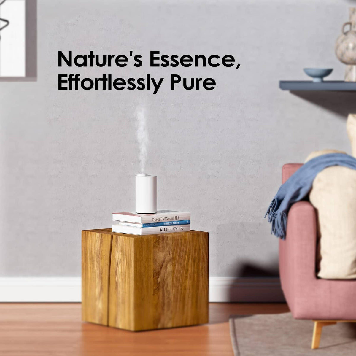 Waterless essential oil diffuser spraying upward mist from a small white top