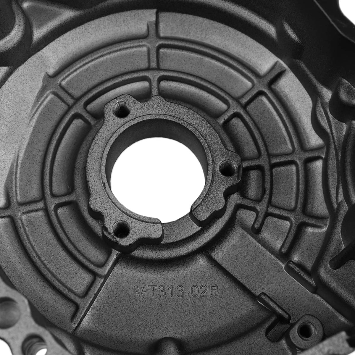 Close-up of grey engine crankcase cover with bolt holes and circular opening