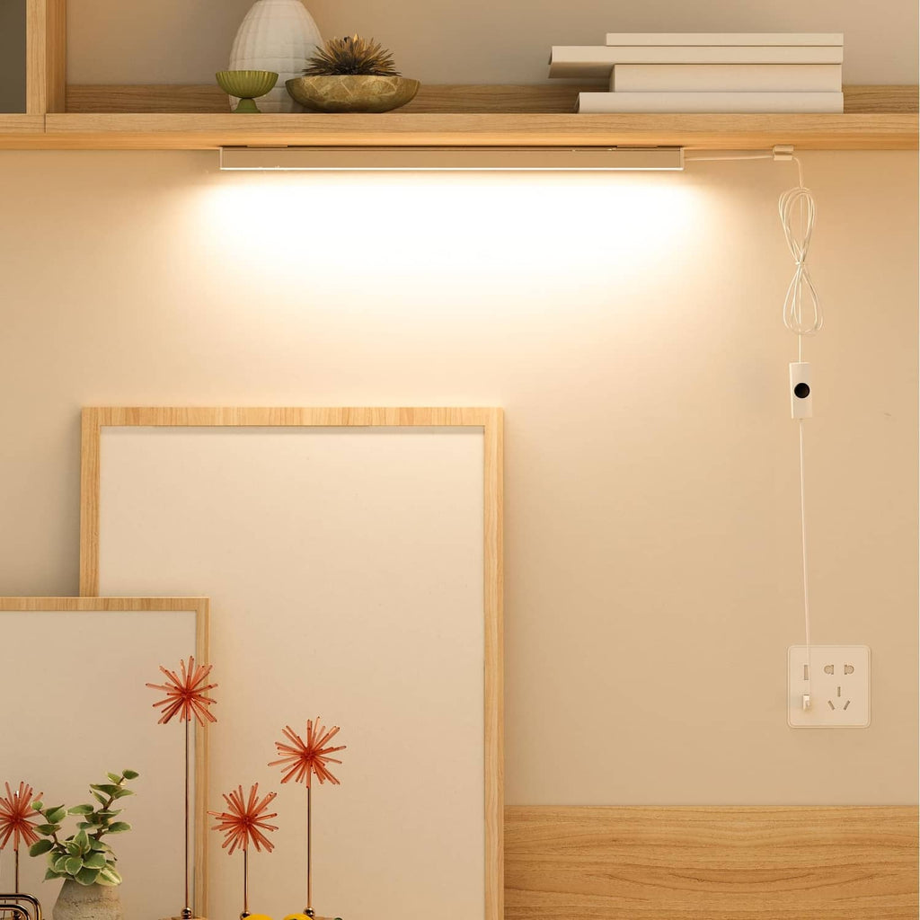 Warm white LED under-cabinet light bar under a shelf with hanging USB cable