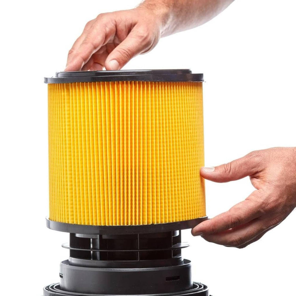 Pleated yellow filter canister with black base and removable top, held in hands
