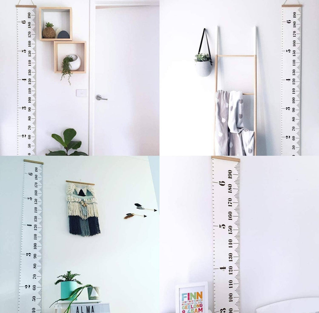 Kids canvas height chart ruler mounted on wall with wood top and inch/cm scale.