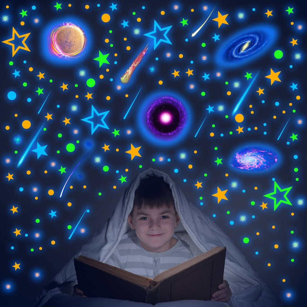 Glow-in-the-dark space wall decals featuring planets, stars, and a colorful rocket motif