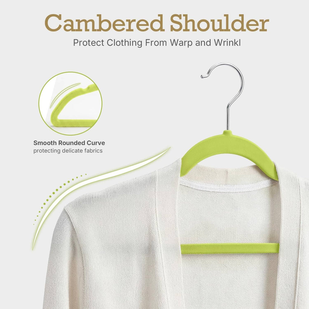 Green velvet hanger with smooth rounded curve shoulder, holding a cream top