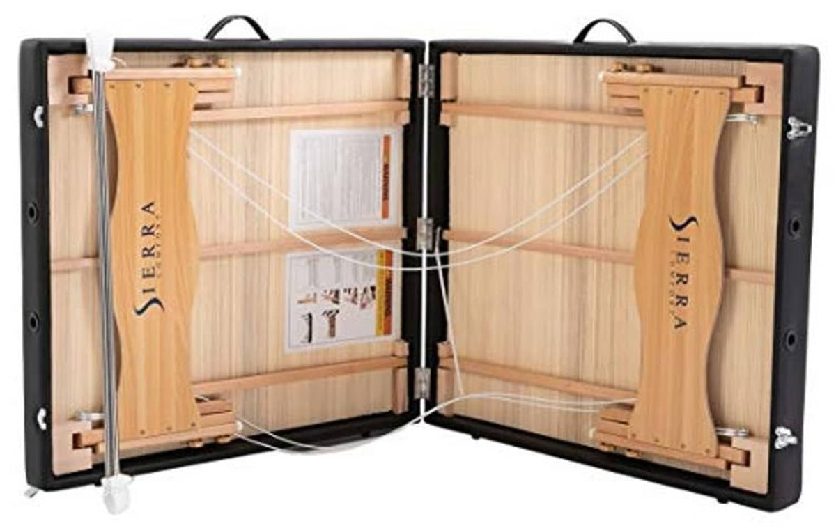 Portable massage table case opened, showing wooden frame supports and padding