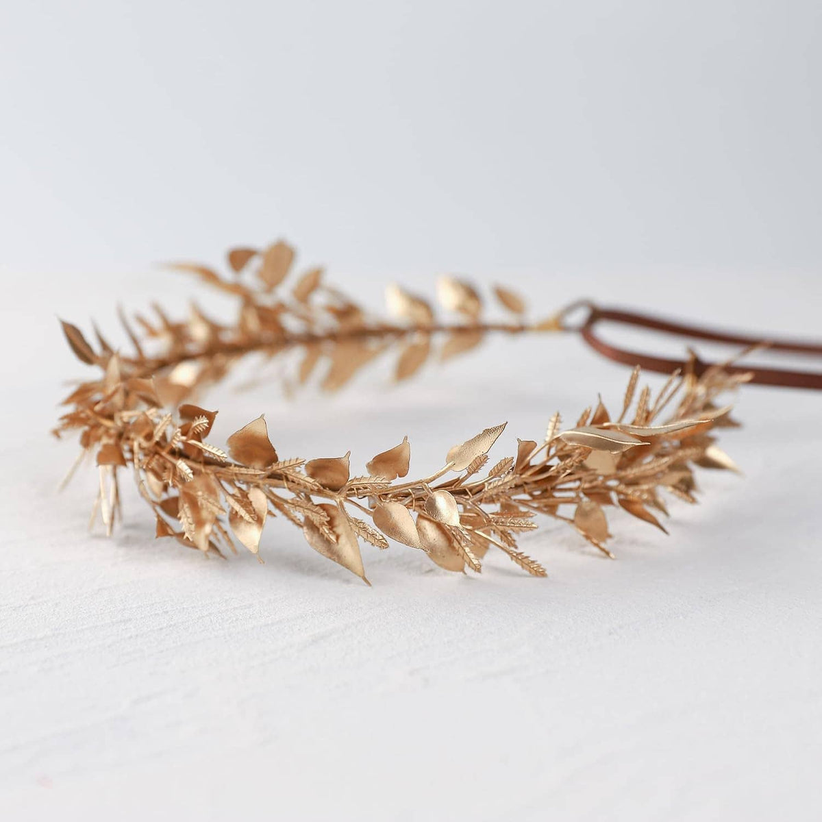 Gold leaf hair crown with brown ribbon band, thin sprigs and leaf clusters