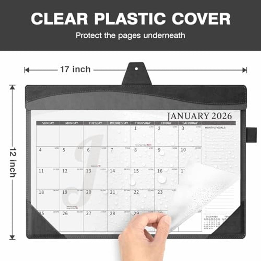 Black leather desk calendar with clear plastic cover protecting the planner pages