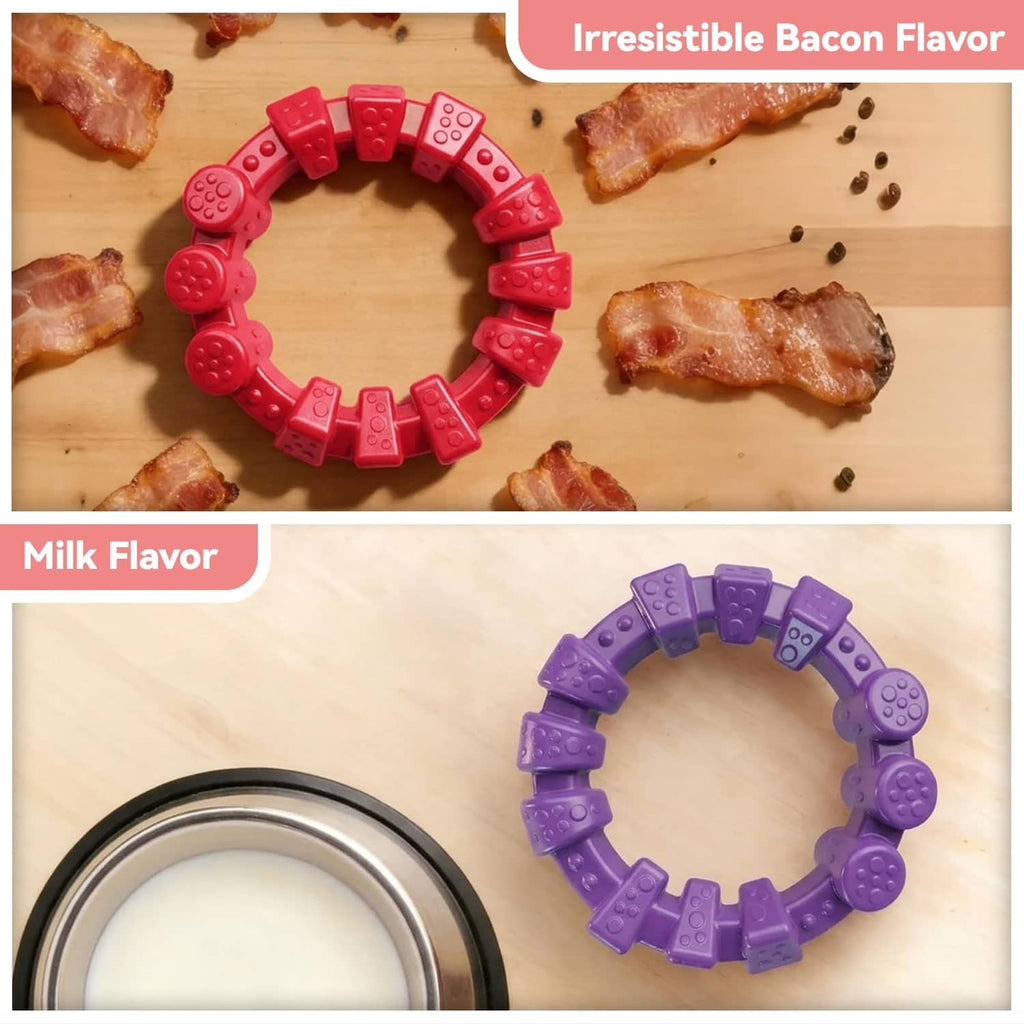 Red and purple bumpy dog chewing ring toys with bacon pieces on a tray