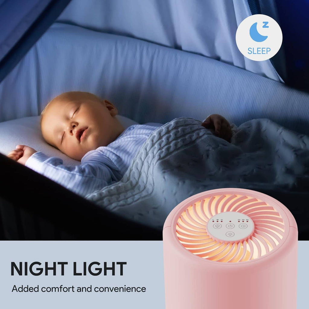 Pink air purifier with glowing top fan grille beside a sleeping child bed
