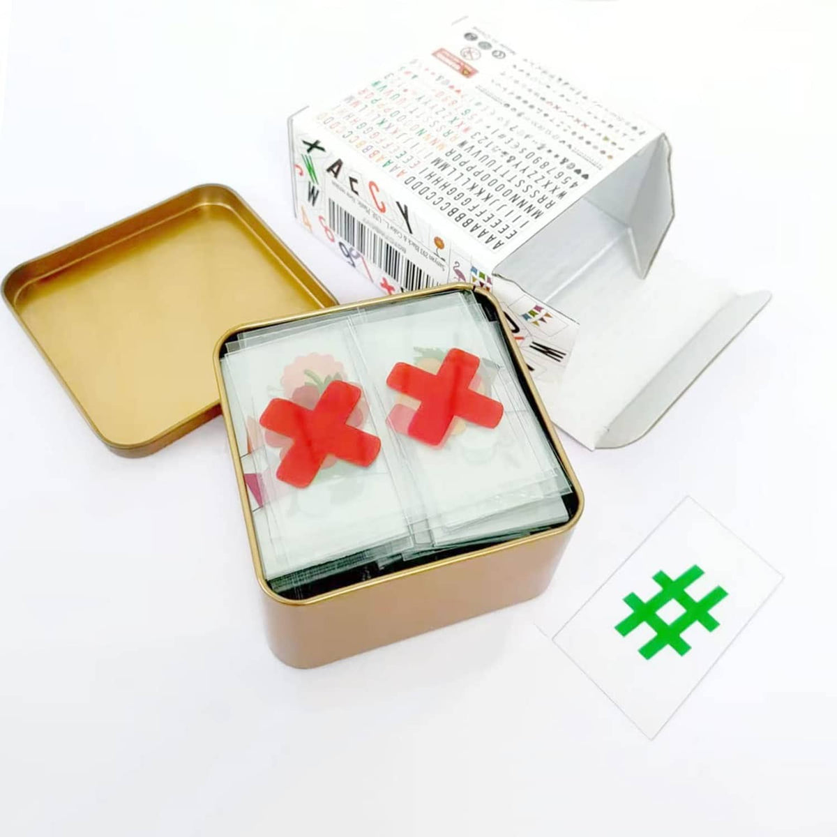 Letter sticker set in gold tin with multicolor symbols sheet and extra sticker pieces