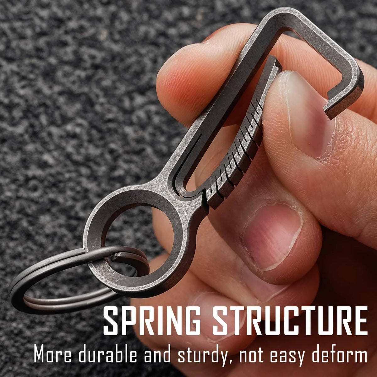Titanium carabiner keychain clip held in hand, showing quick-release gate