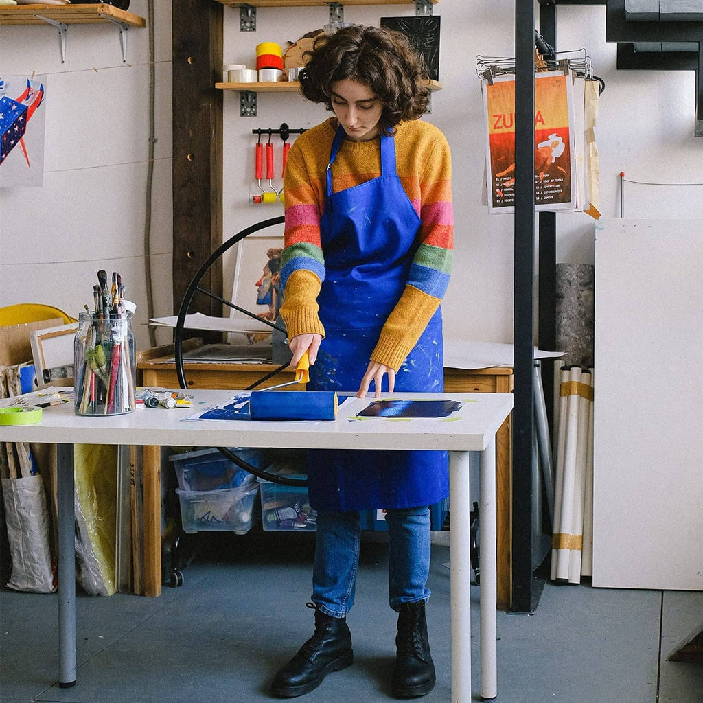 Blue painter’s tape on a worktable, ready for use while painting.