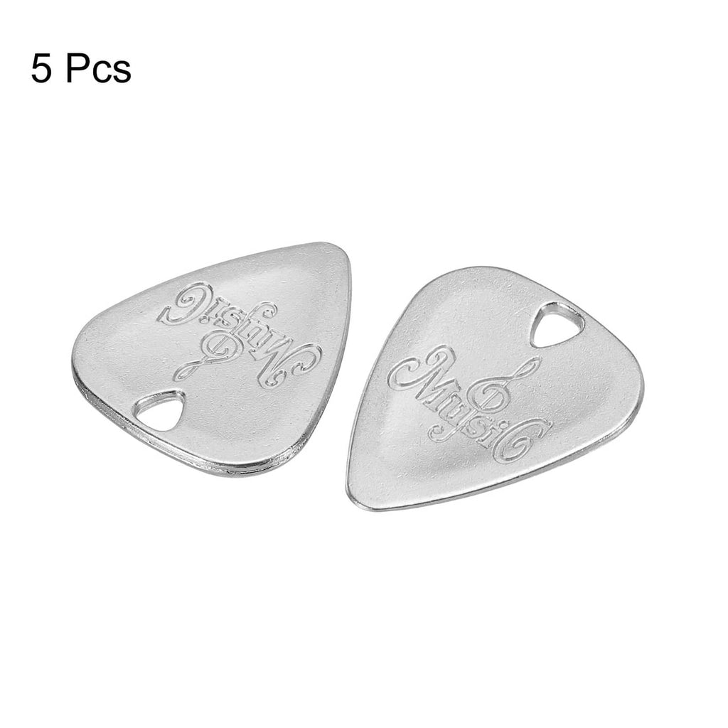 Five triangular metal guitar picks in silver tone, each with a round finger notch