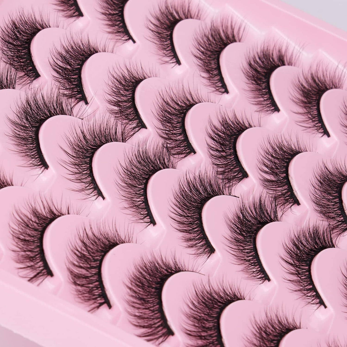 Close-up of fluffy dark cat-eye false eyelashes with curved wisps