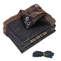 Dark shade cloth mesh tarp, folded with rust pinstripe trim and metal grommets
