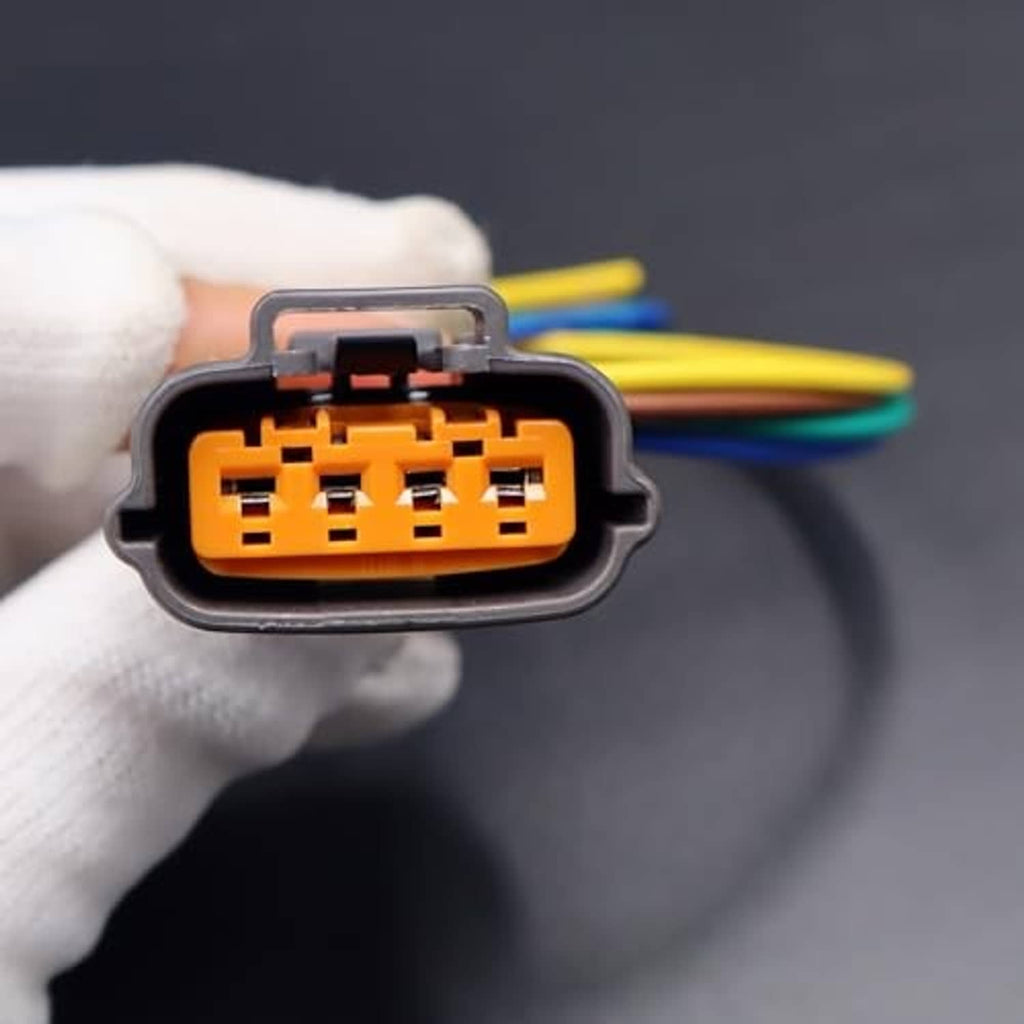 Close-up of gray 4-pin TPS connector with orange pin block and multicolor wires