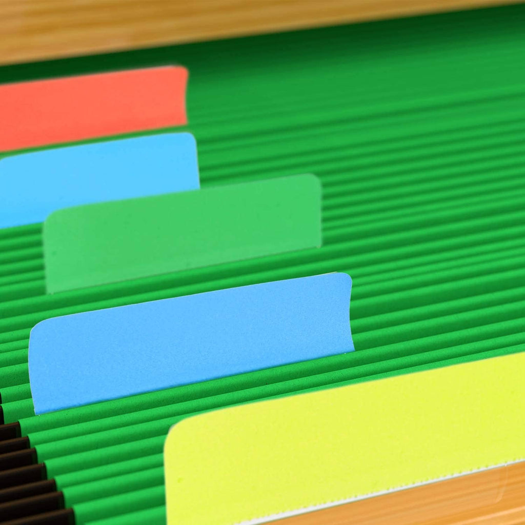 Assorted sticky index tabs peeking from beneath green paper strips.