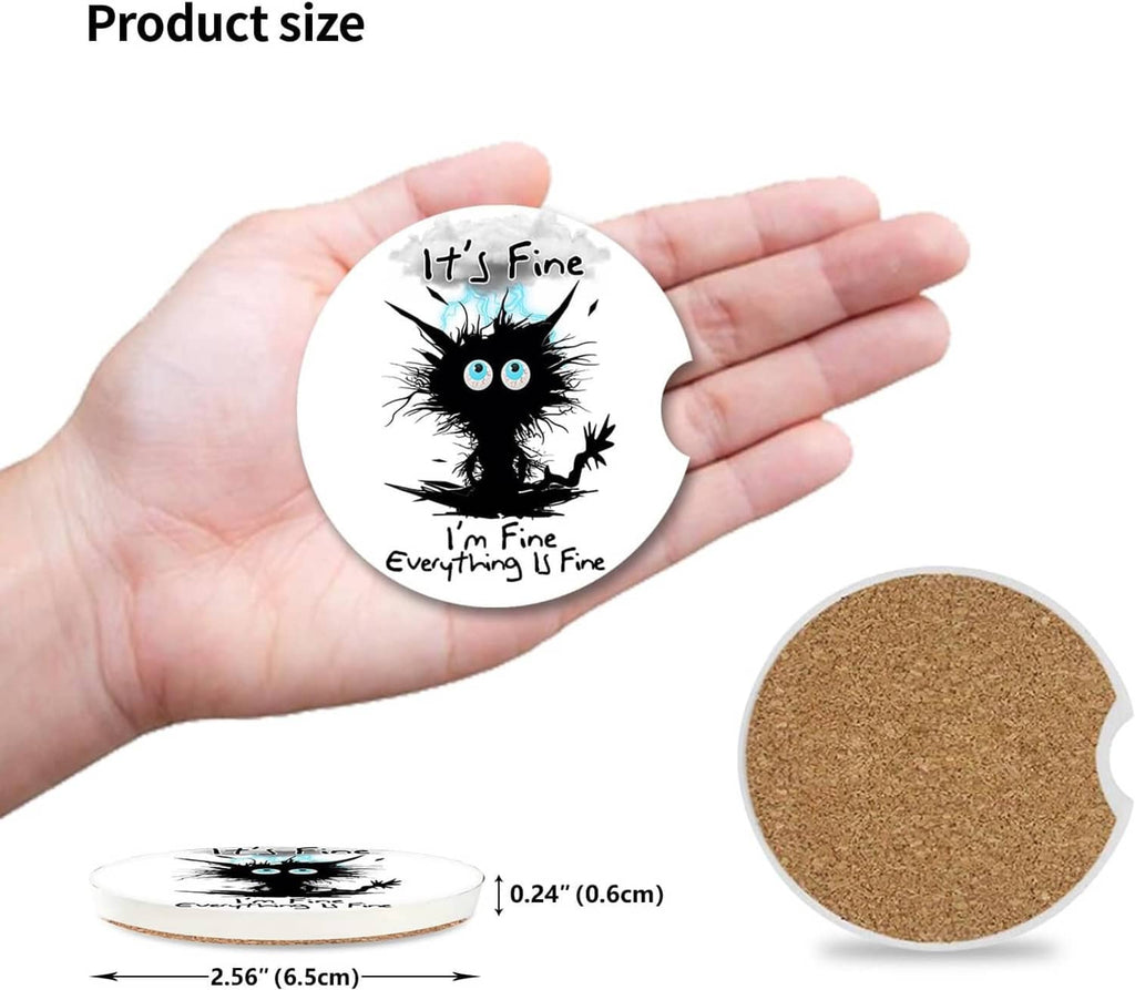 Small round ceramic coaster held in hand with cork back and cat graphic front