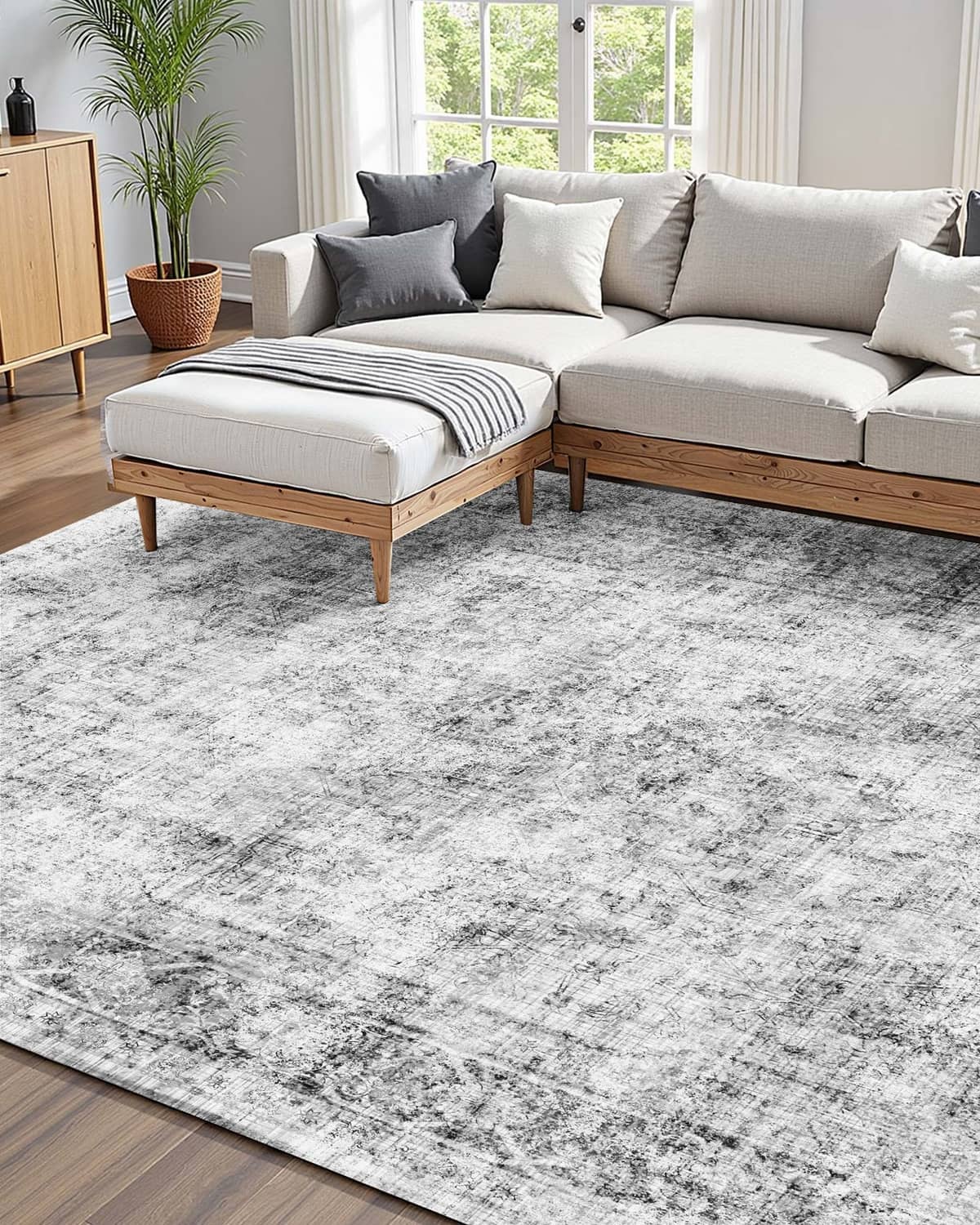 Gray abstract area rug with distressed finish in a modern living room setting