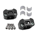 Black motorcycle handlebar clamp riser with mounting bolts and silver split inserts