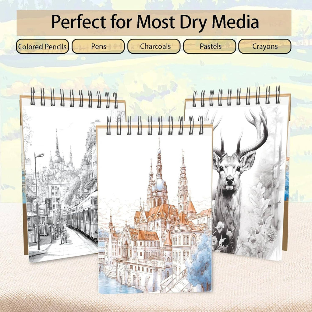 Three spiral-bound sketch pads with illustrated covers for dry media, including deer and city.