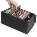 Black CD storage box holding multiple jewel cases, front open with discs visible