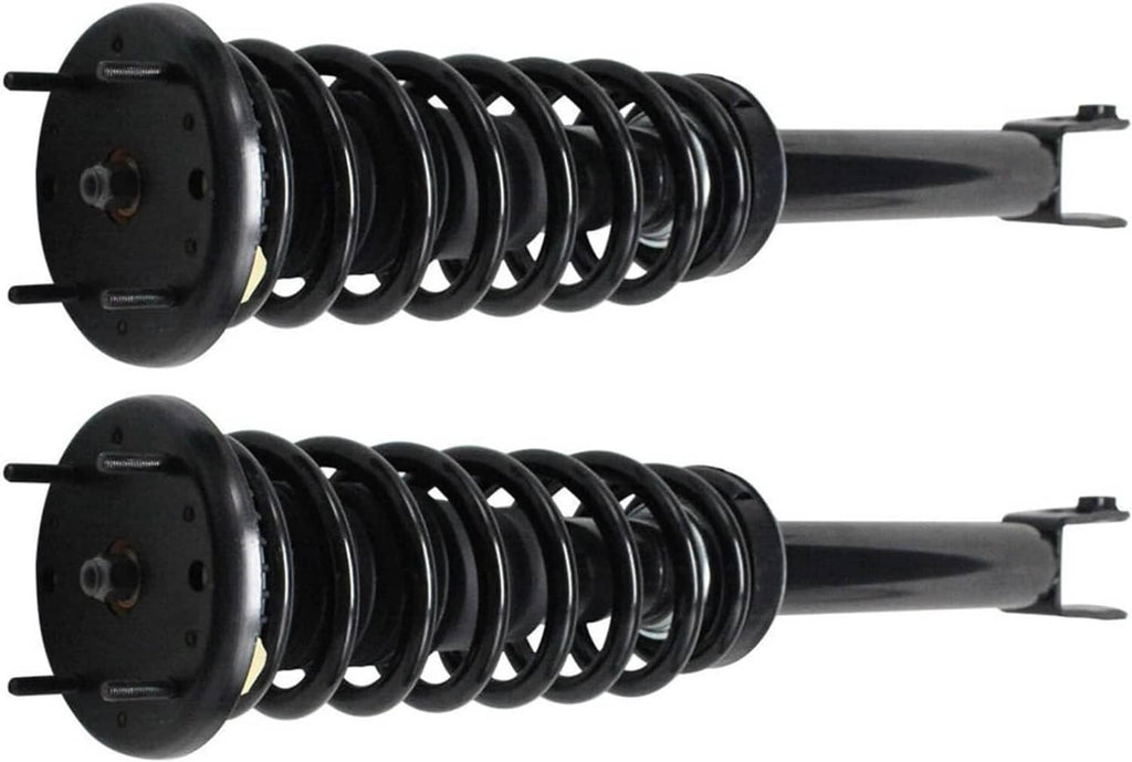 Pair of front shock struts showing black coil springs and top mounting plates