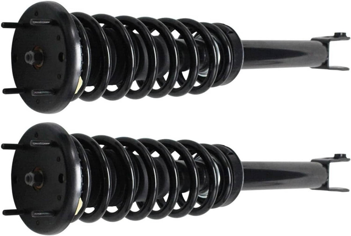 Pair of front shock struts showing black coil springs and top mounting plates