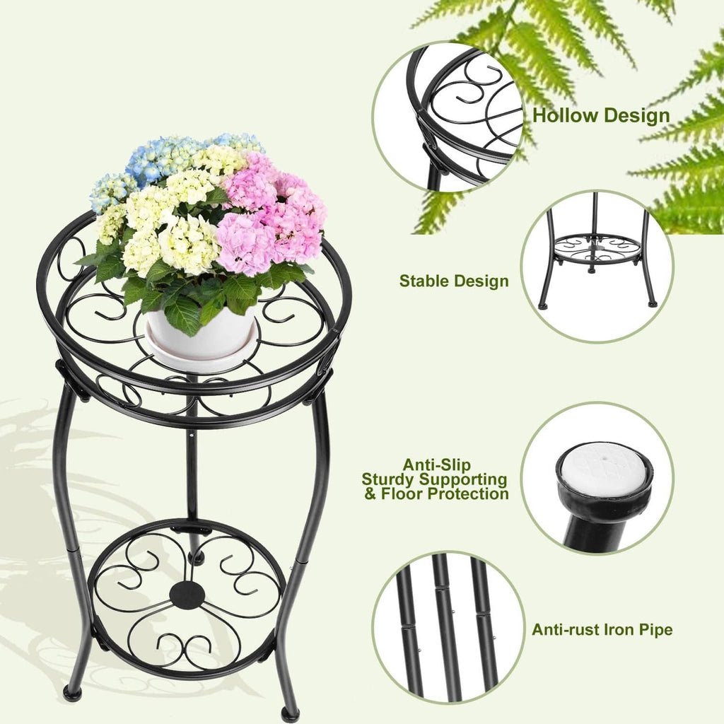 Black 2-tier metal plant stand with round shelves and ornate scroll pattern, holding flowers