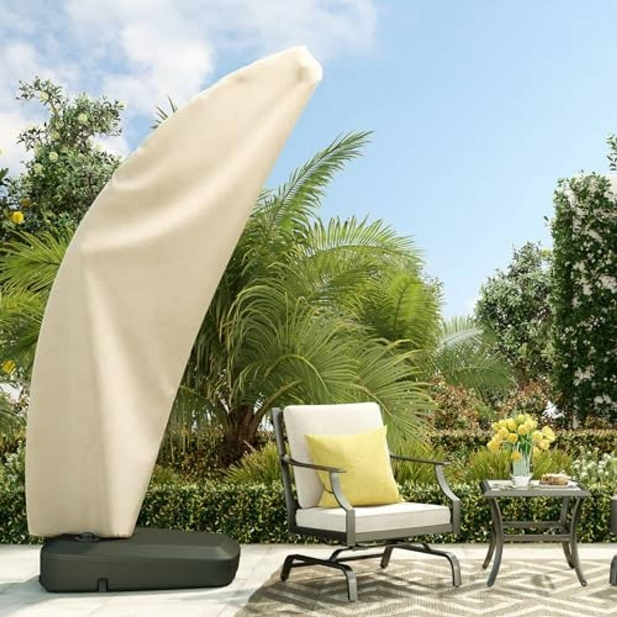 Cream offset patio umbrella cover with dark band, covering an umbrella on a patio