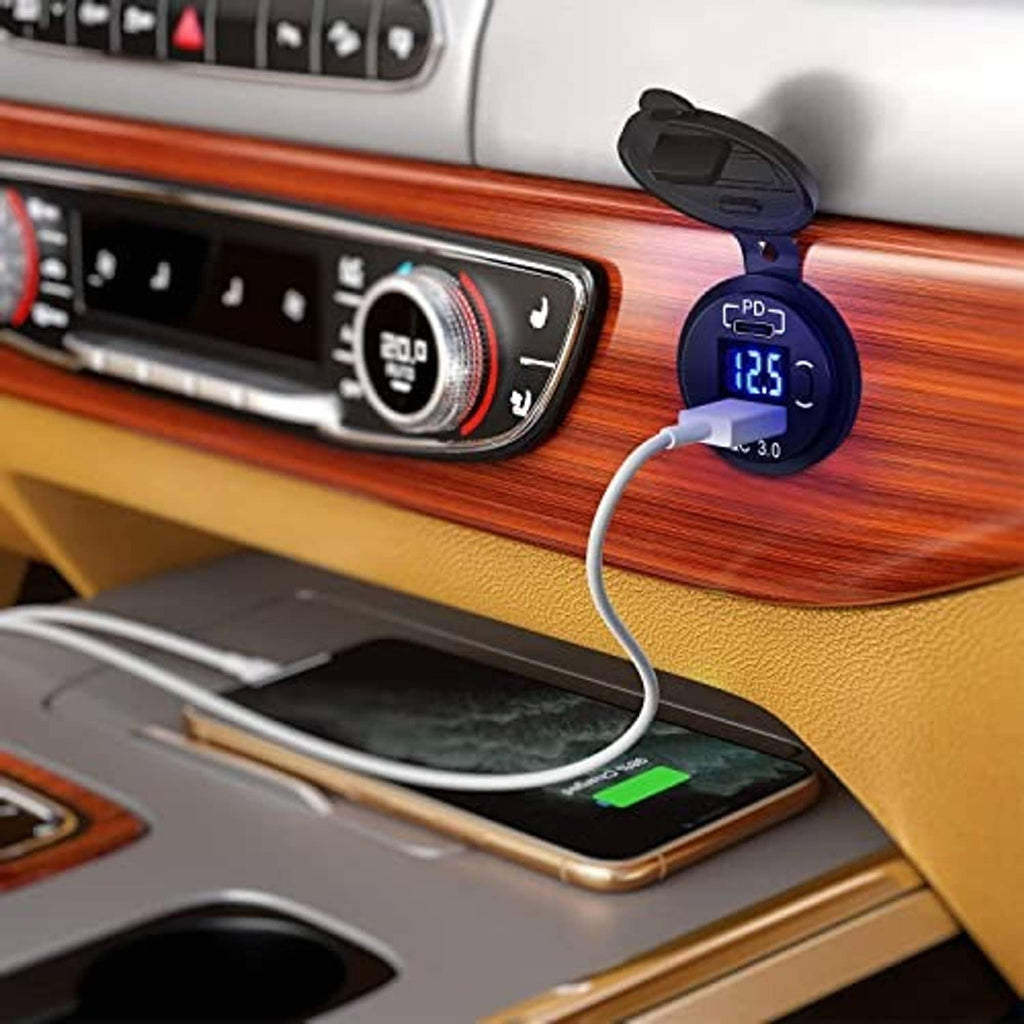 Blue voltmeter display on USB-C car charger socket with power cable plugged in