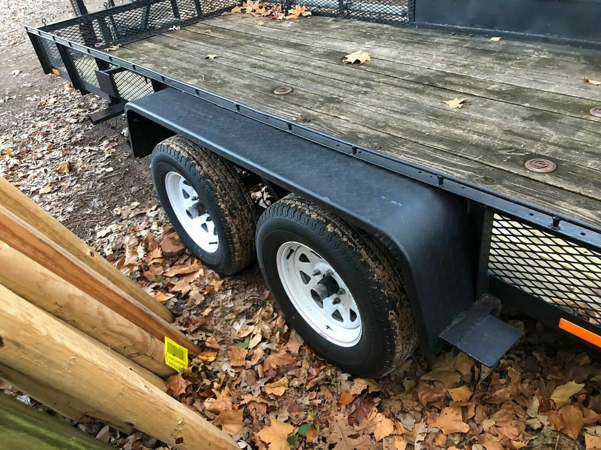 Mounted steel diamond tread trailer fenders with white wheels on a tandem axle trailer
