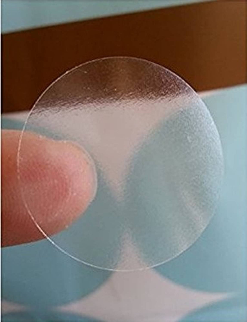 Clear 2-inch round seal sticker close-up, transparent film edge