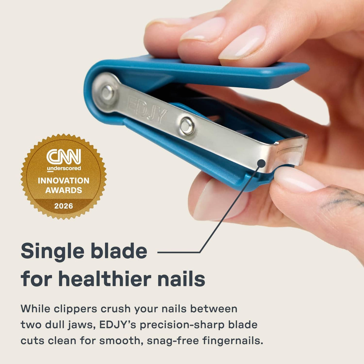 Blue fingernail clipper held in hand, single-blade cutter