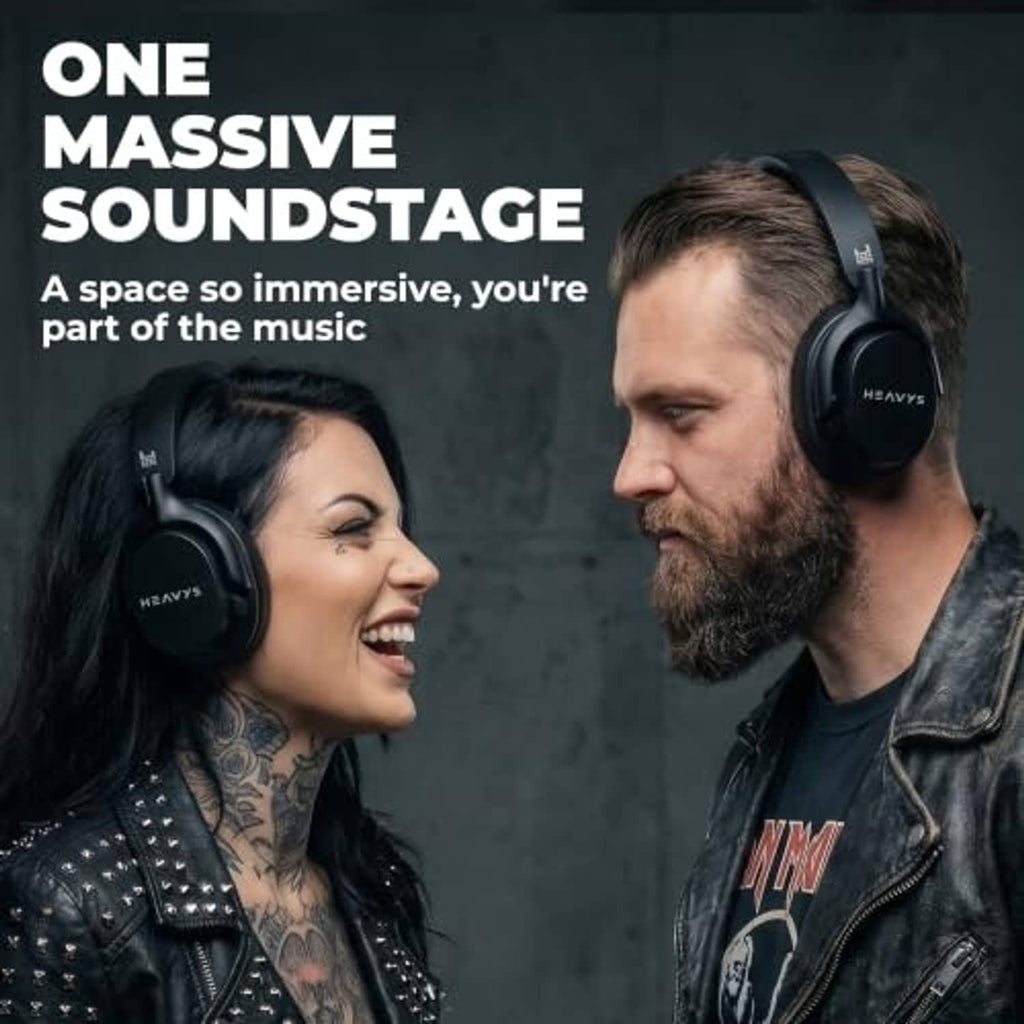 Black over-ear wireless headphones on a person, with padded headband and ear cups.