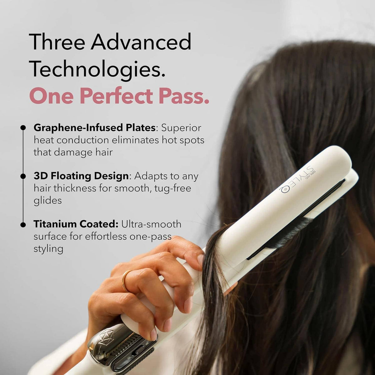 White flat iron hair straightener with black plates, held against long hair.