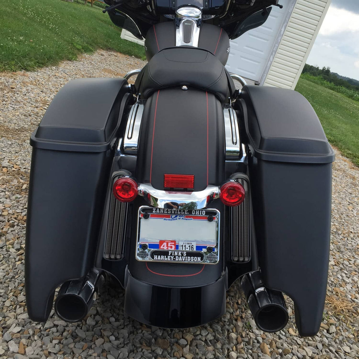 Rear view of motorcycle with red vertical LED fascia lights and turn signals in black trim