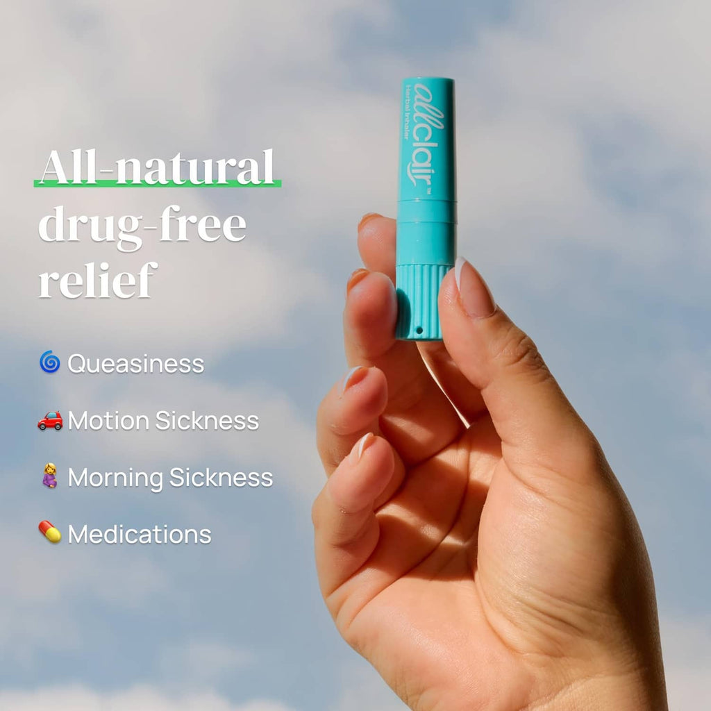 Turquoise herbal inhaler stick held upright in a hand outdoors