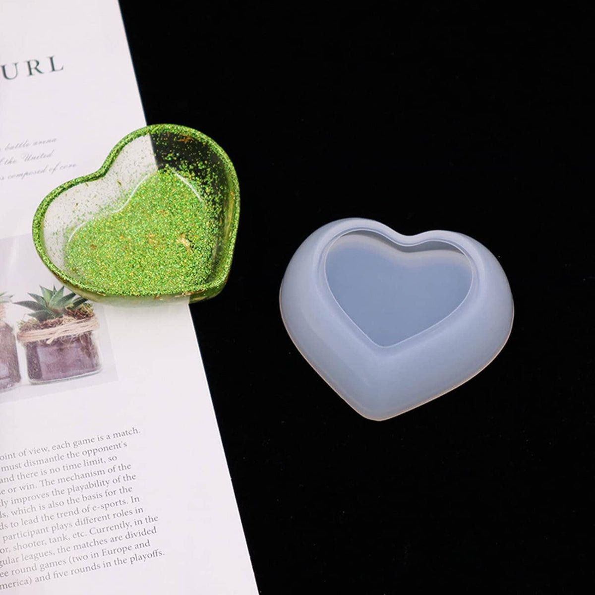 Heart-shaped resin storage mold bowls, one green glitter-filled and one clear blue