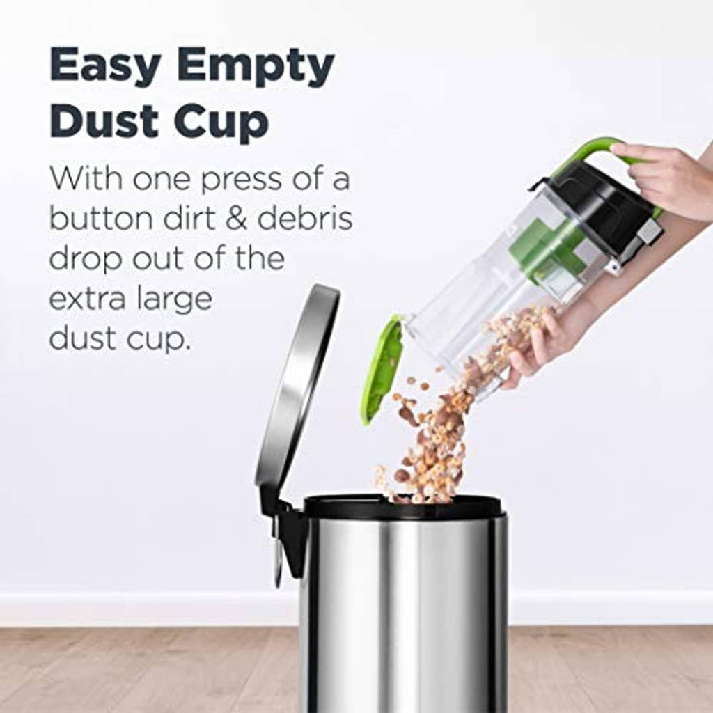 Green bagless upright vacuum with extra-large dust cup releasing debris into bin