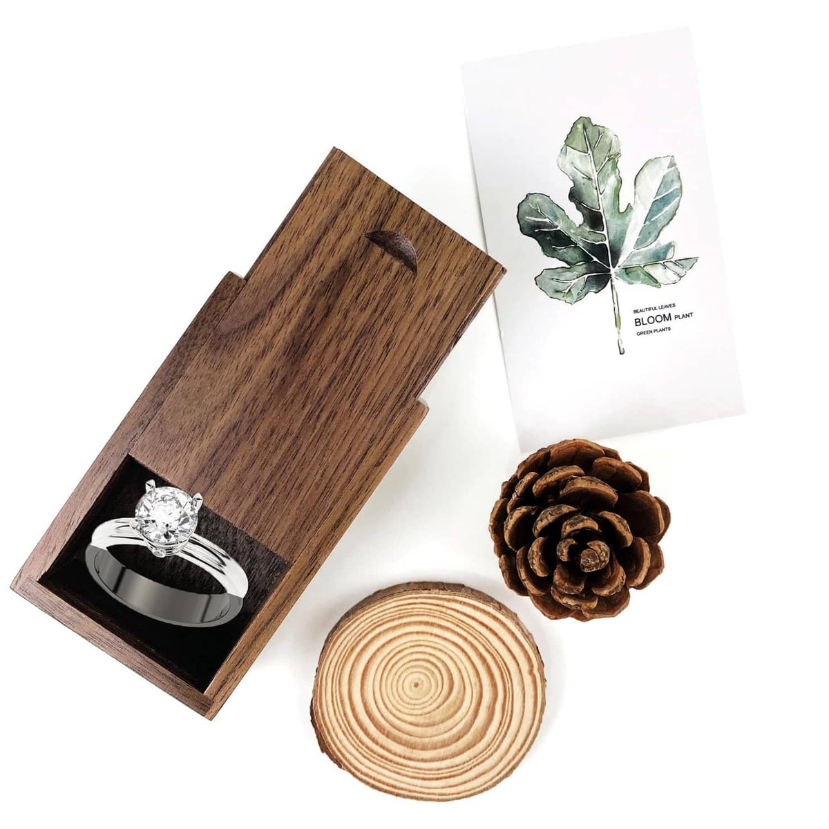 Small wooden gift box with sliding lid, open with ring in dark insert