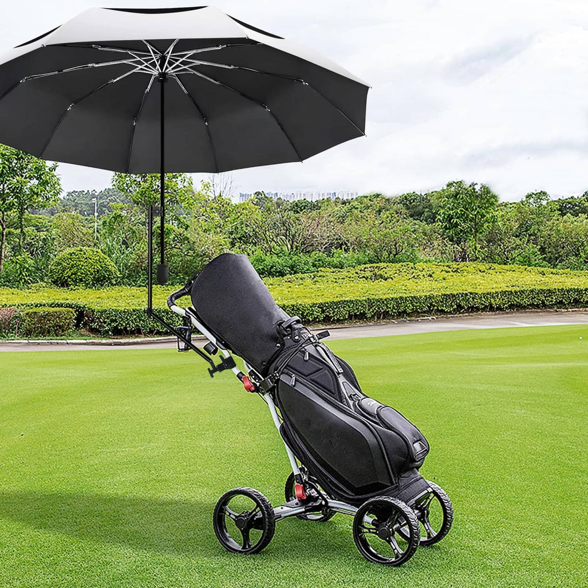 Golf umbrella mounted on a black push cart with dark canopy and rain coverage.
