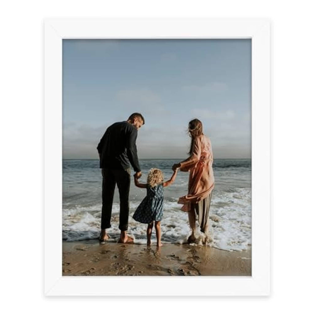 White 8x10 picture frame showing a beach family photo behind clear glass