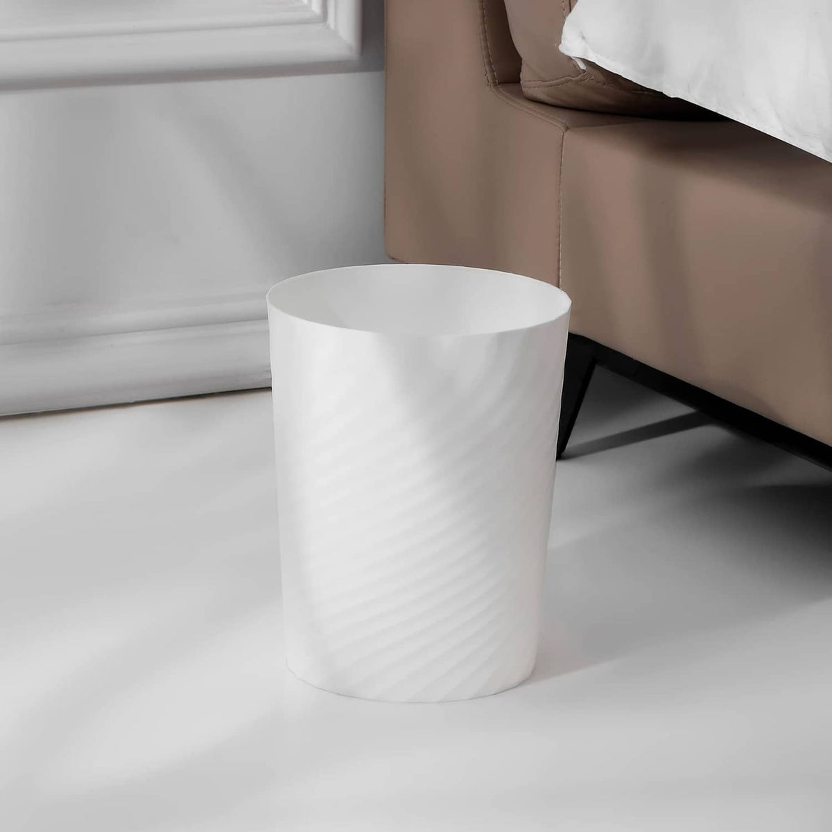 White plastic small wastebasket with ridged texture and open top