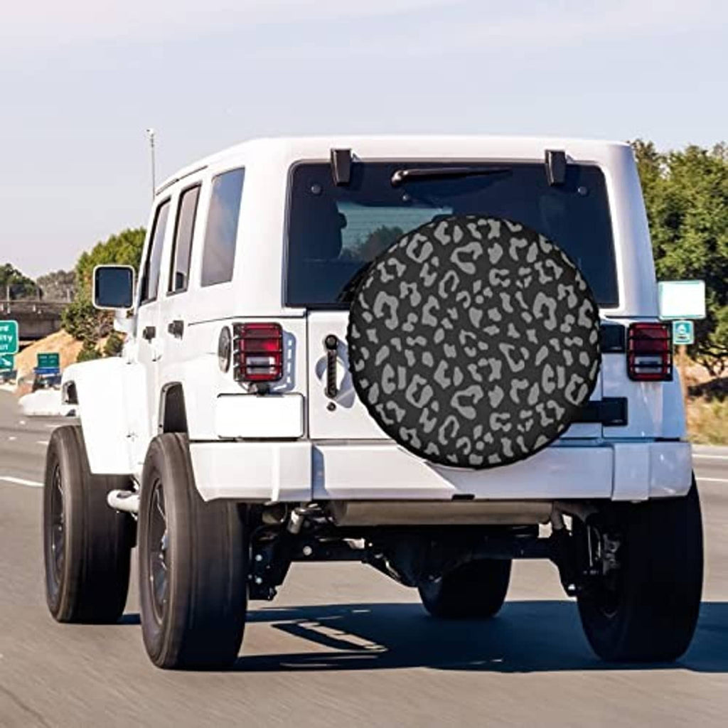 Leopard-print spare tire cover on white SUV tailgate, black circular cover